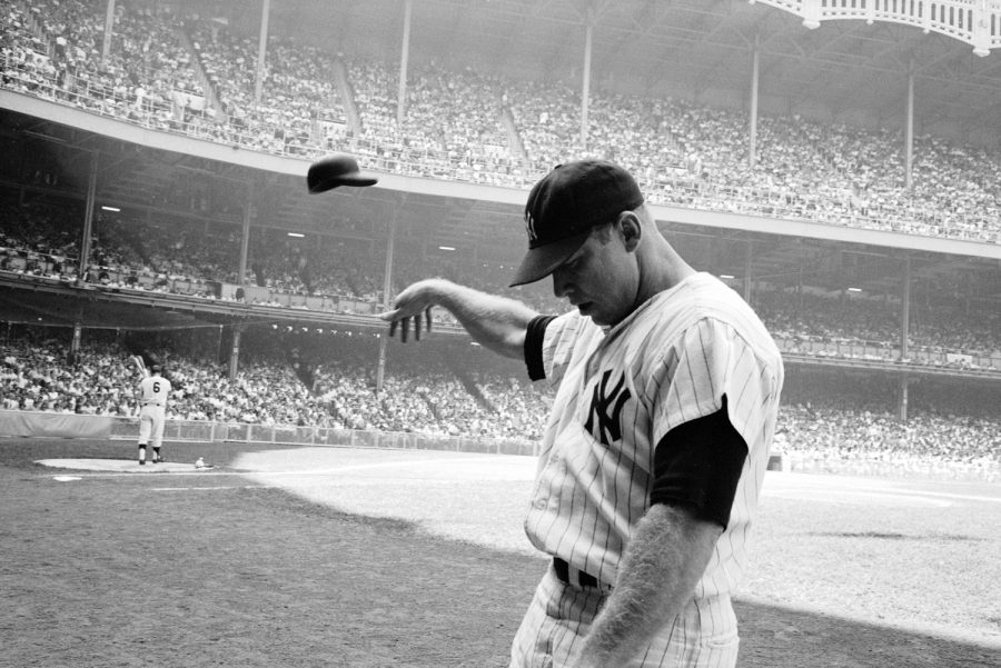 Yankee Mickey Mantle flinging his batting helmet away in disgust during bad day at bat.