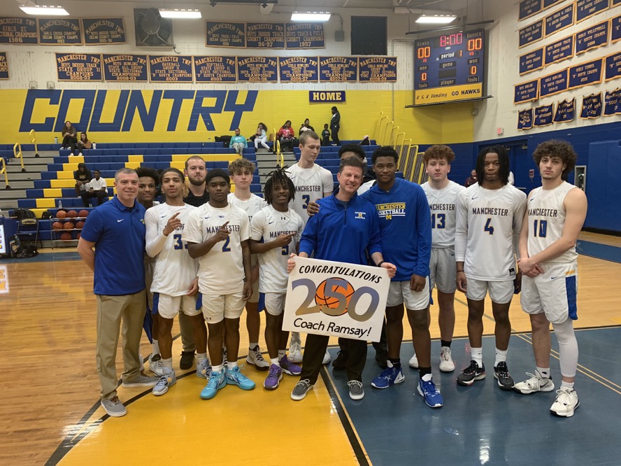 Coach Ramsay poses with his players at the first home game on January 19, 2023 after his 250th win on January 14, 2023 when the Hawks beat Pinelands 50-48. Photo by Mr. Lister, Athletic Director.