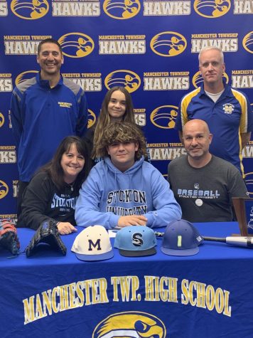 Joe Sclama with Coach Beauchemin, Coach Holzer, and his family. Photo courtesy of Mr. Lister.