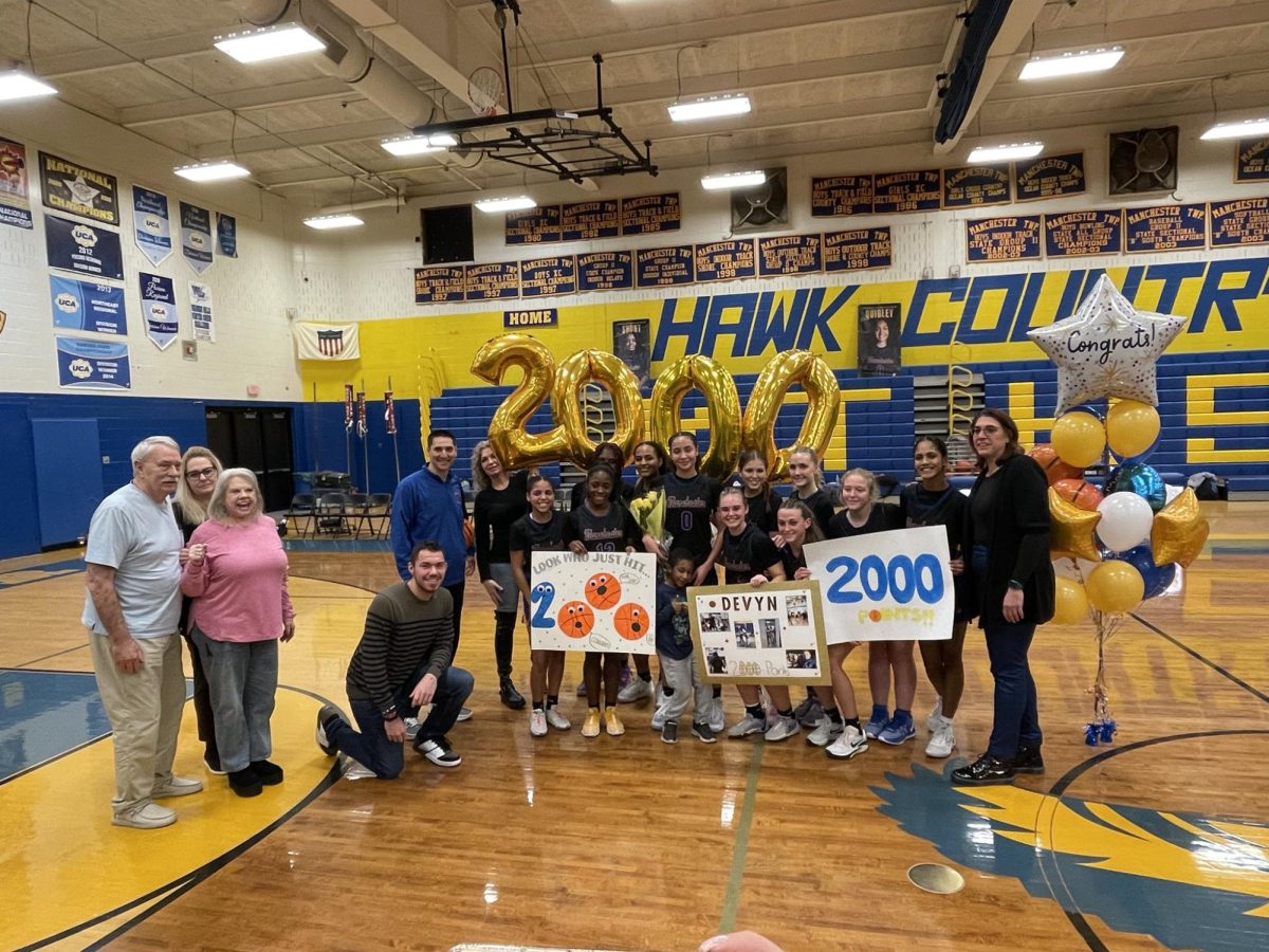 Devyn Quigley and her teammates after scoring her 2,000th point on Wednesday, January 11, 2024. Photo courtesy of Manchester Twp. H.S. Sports Updates on Twitter @MTHS_Sports
